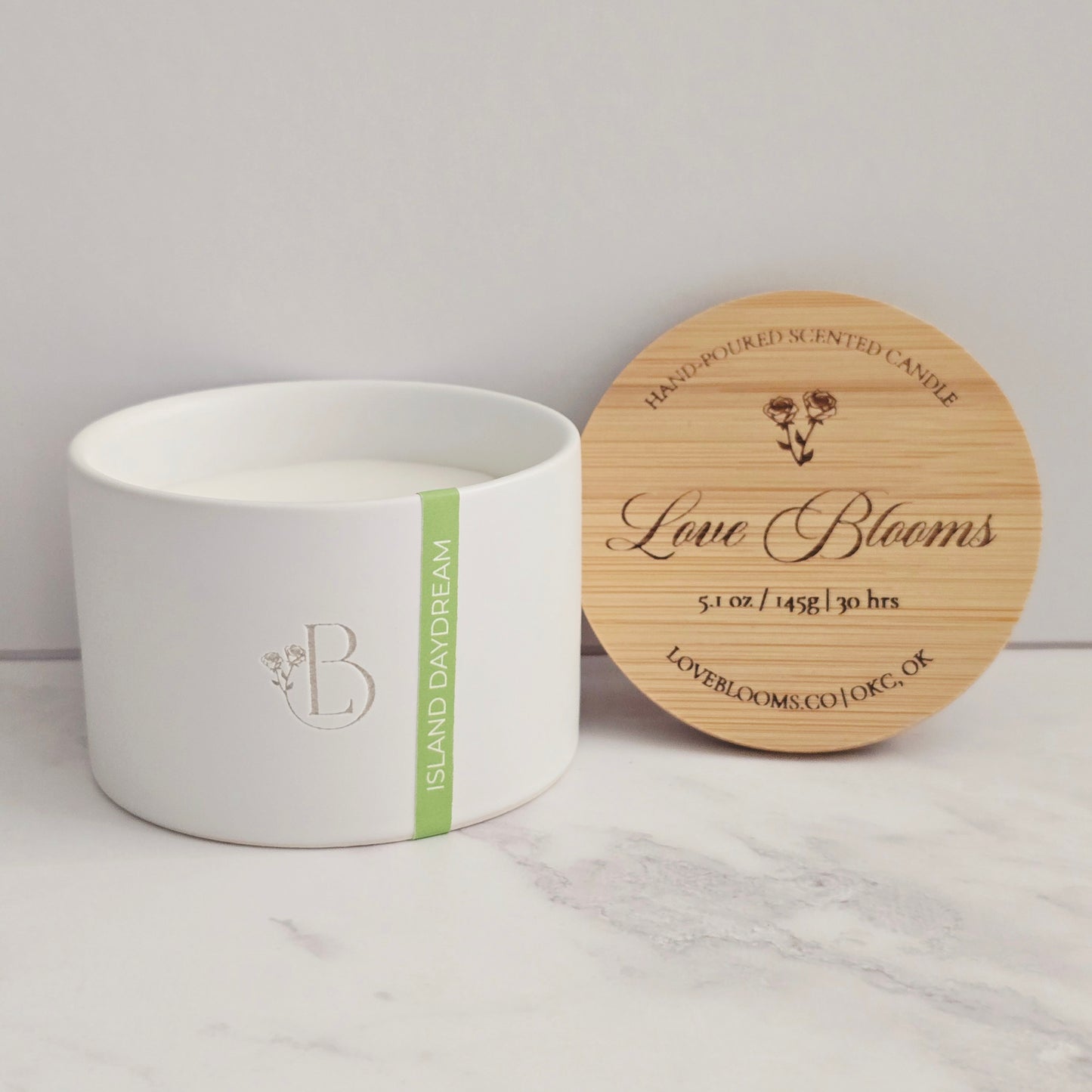 White candle with a wooden lid on a light gray surface