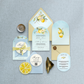 Invitation set with lemon-themed design on a gray fabric background