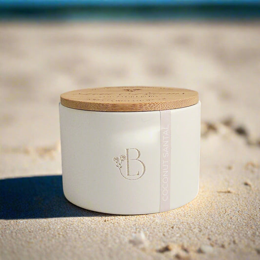 White storage jar with wooden lid on a light surface