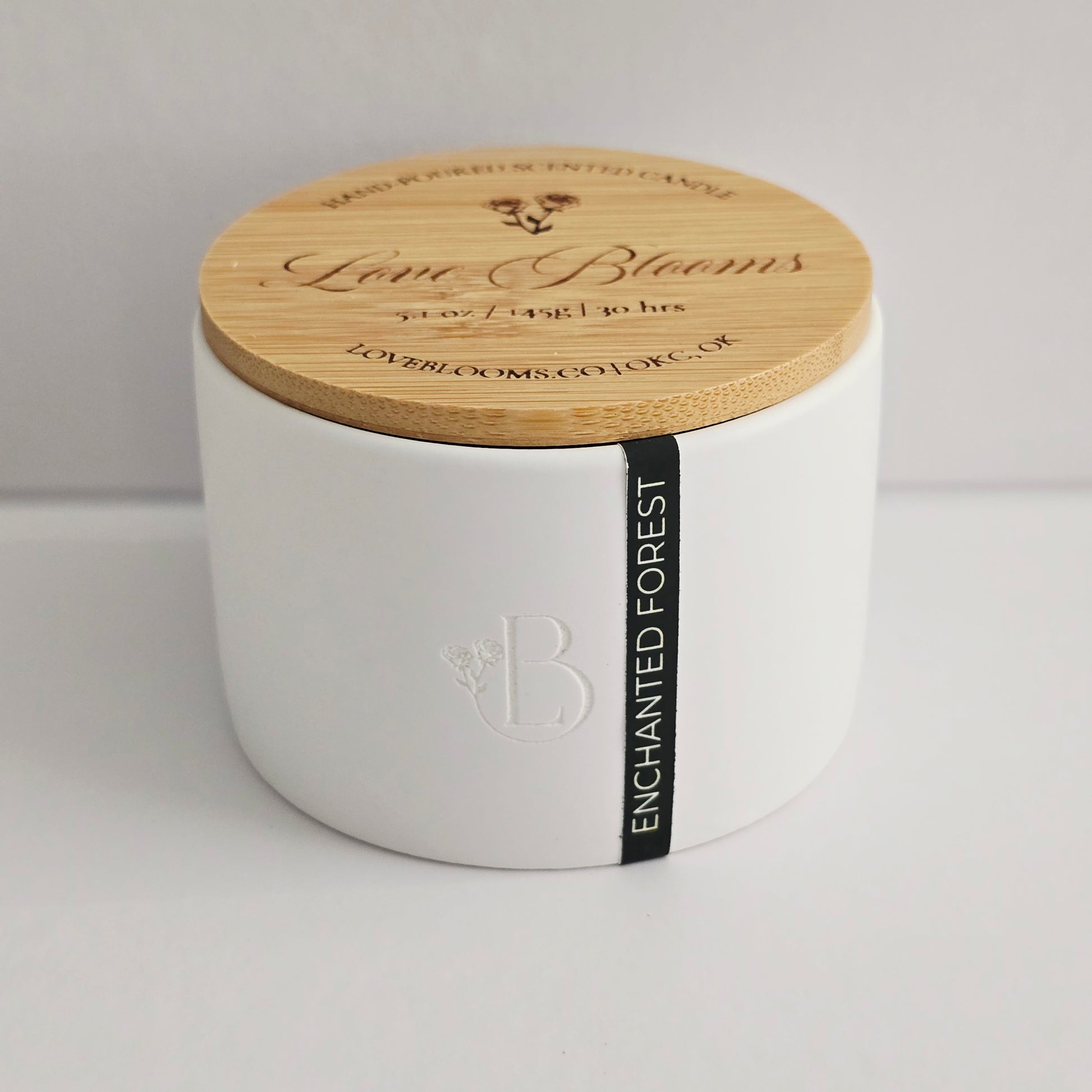 White candle with a wooden lid on a light gray background