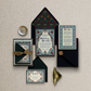 Decorative wedding invitation set with floral designs on a textured surface
