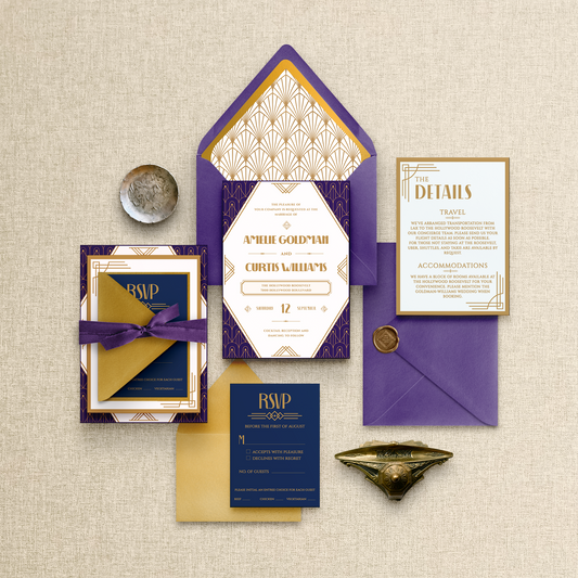 Elegant wedding invitation set with purple and gold accents on a textured beige background.
