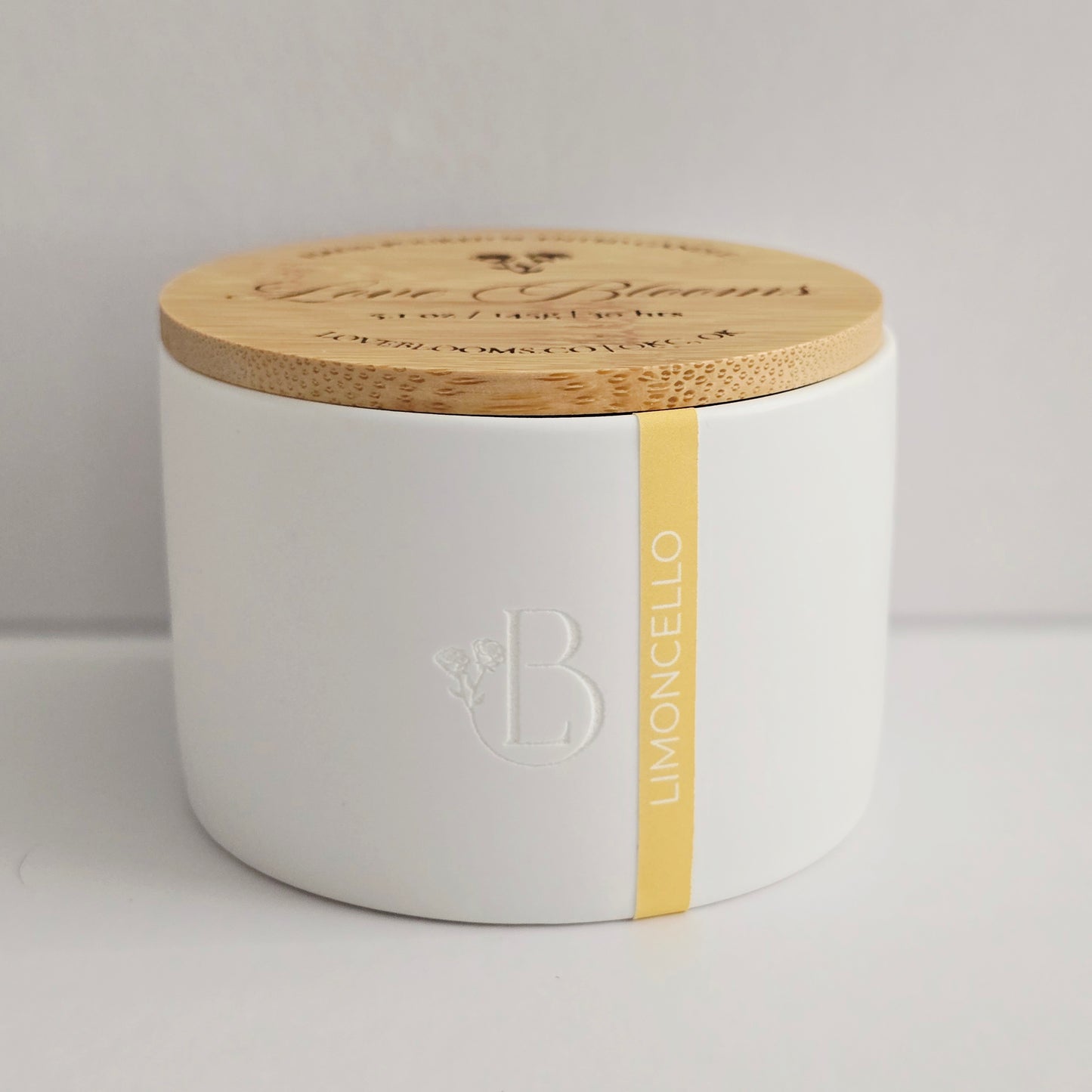 White container with wooden lid featuring branding on a light gray background
