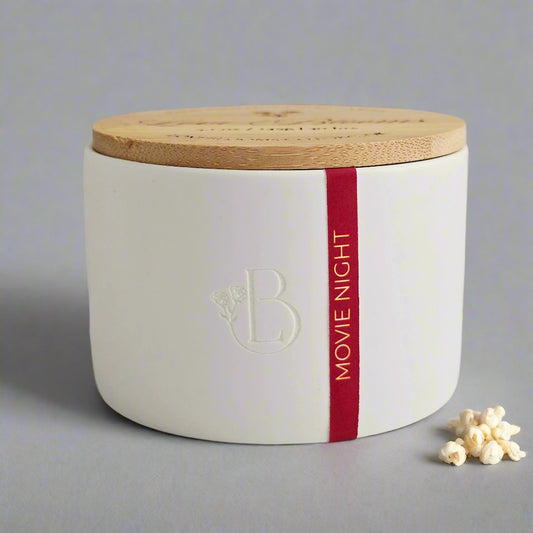 popcorn scented candle in mini white ceramic jar with bamboo lid