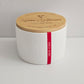 White container with a wooden lid featuring 'Love Blooms' branding on a light gray background.