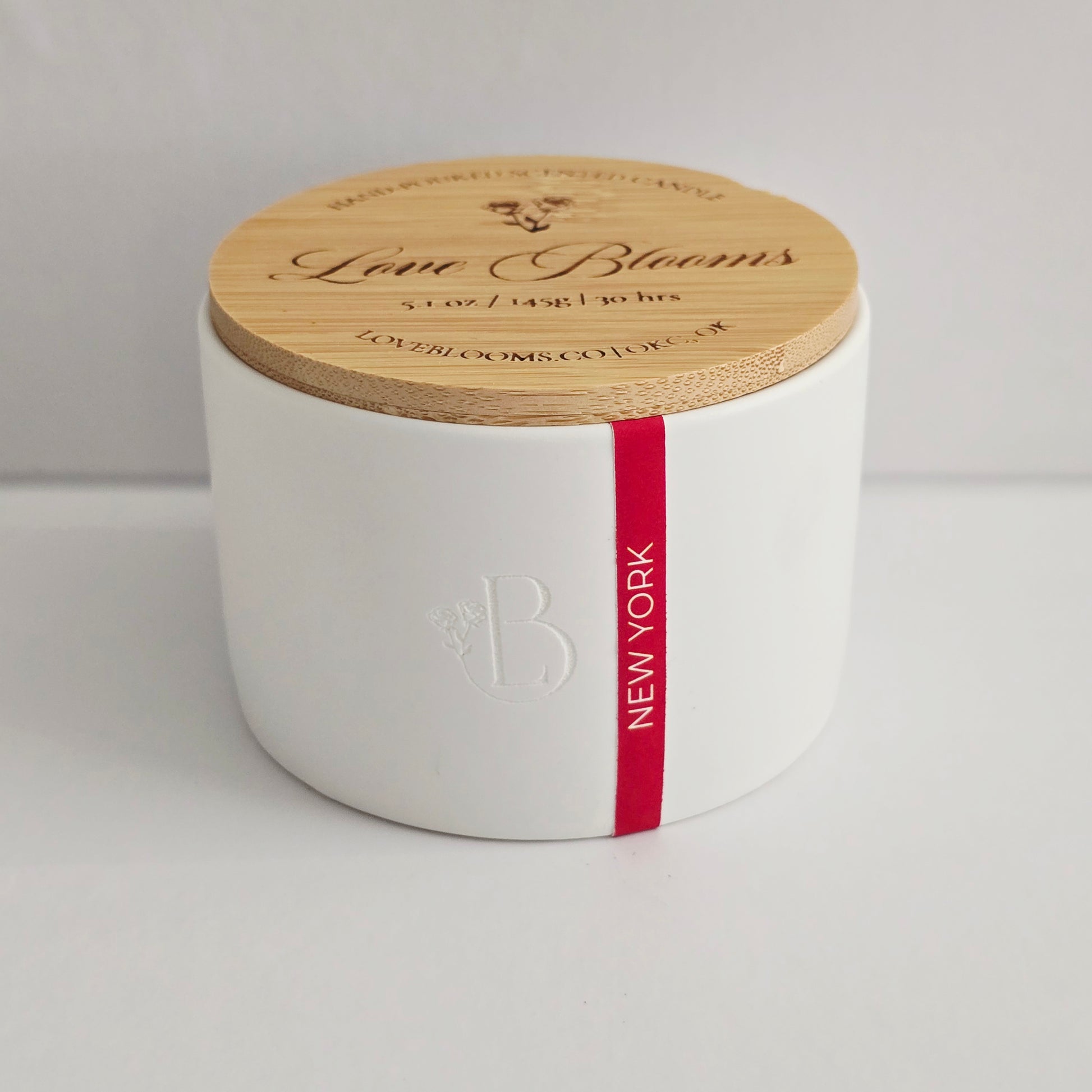 White container with a wooden lid featuring 'Love Blooms' branding on a light gray background.