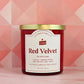 Red velvet candle with gold lid on a pink geometric patterned background