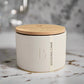 White container with wooden lid on a marble surface
