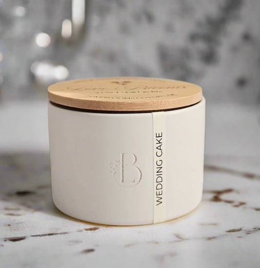 White container with wooden lid on a marble surface