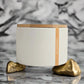 White container with a wooden lid on a light gray background