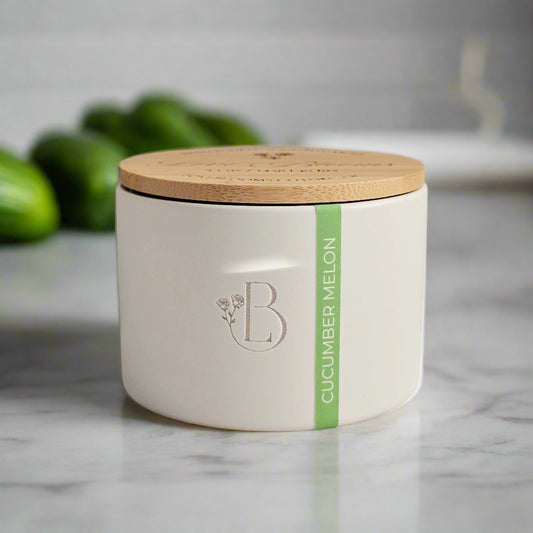 White container with a wooden lid on a marble surface