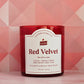 Red velvet candle with a label on a pink geometric patterned background